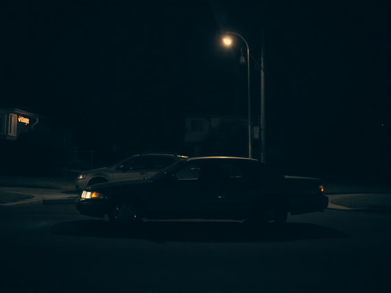 San Diego criminal investigation defense attorney: unmarked detective car parked on a quiet street during an investigation